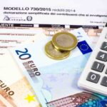 modello 730, calcolatrice e soldi con spiccioli